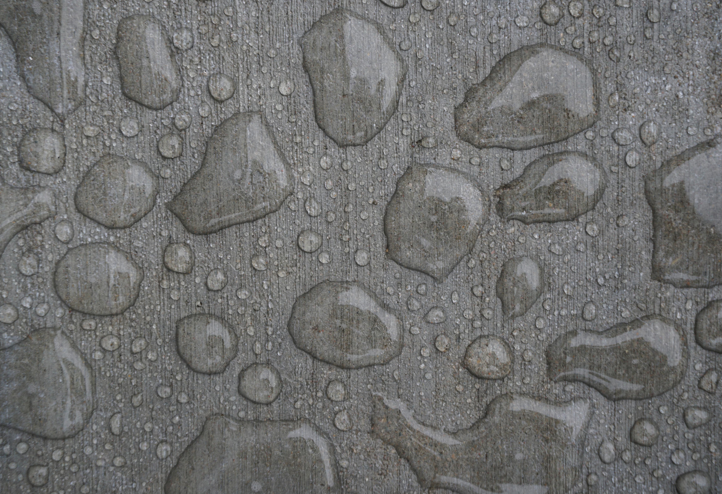 How Often Should You Seal Pavers in Florida? 3 Water beading on a sealed concrete surface