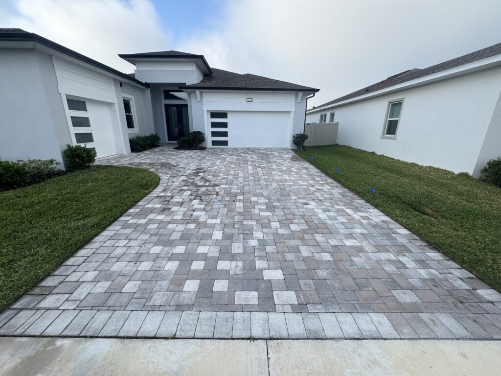 How Irrigation Overspray Affects Pavers in Florida 2 Unsealed paver driveway exposed to Florida weather and irrigation